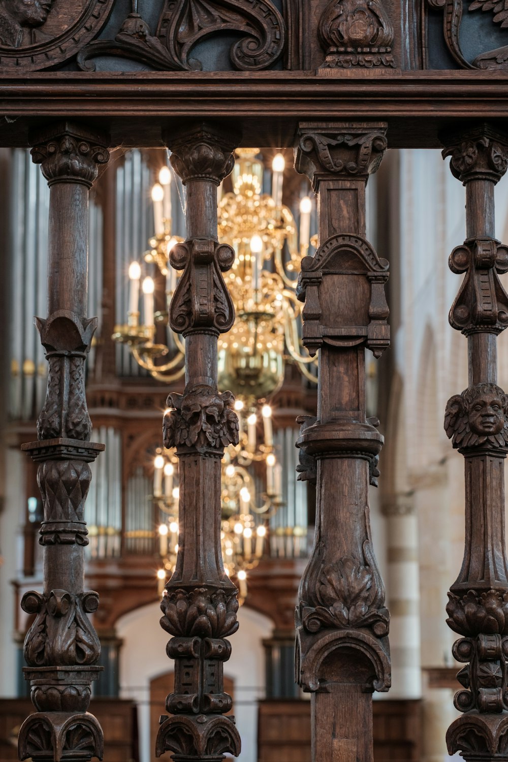 an ornate wooden structure with a chandelier in the background