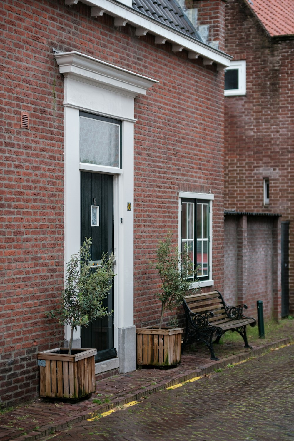 a brick building with a wooden bench in front of it