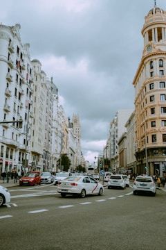a city street filled with traffic next to tall buildings