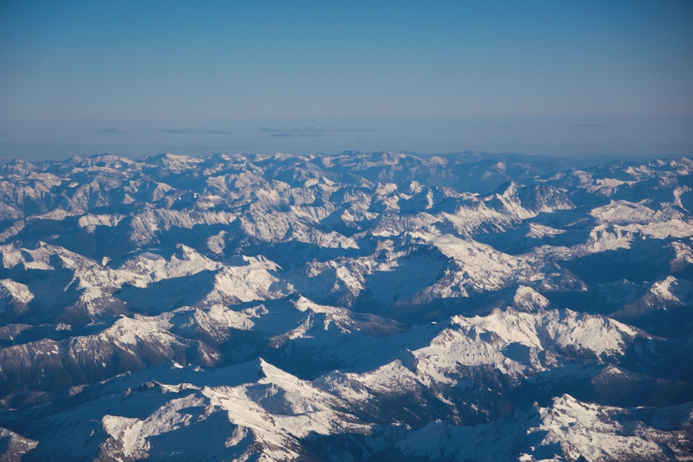 a view of snow covered mountains from an airplane