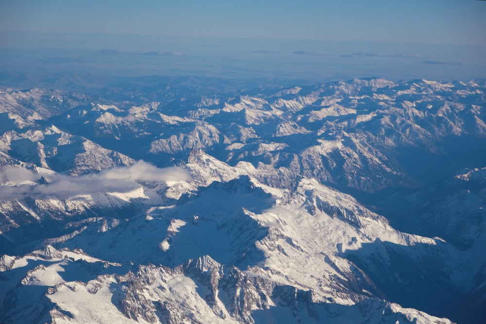 a view of snow covered mountains from an airplane