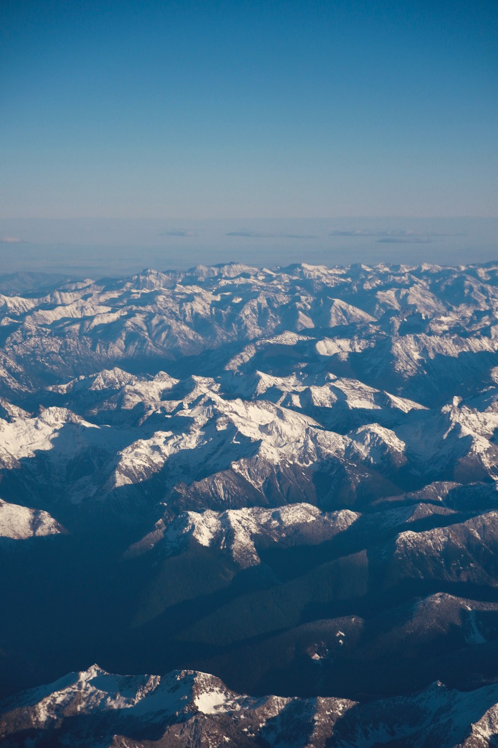 a view of snow covered mountains from an airplane