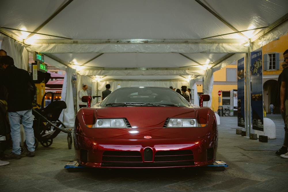 a red sports car parked in a garage