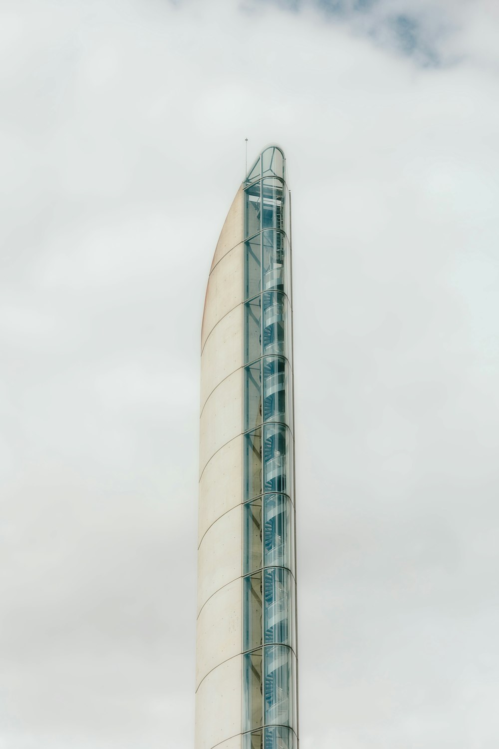 a tall building with a curved glass front