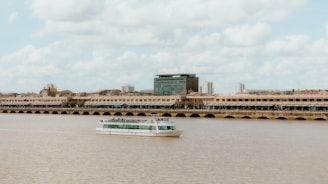 a large white boat floating on top of a river