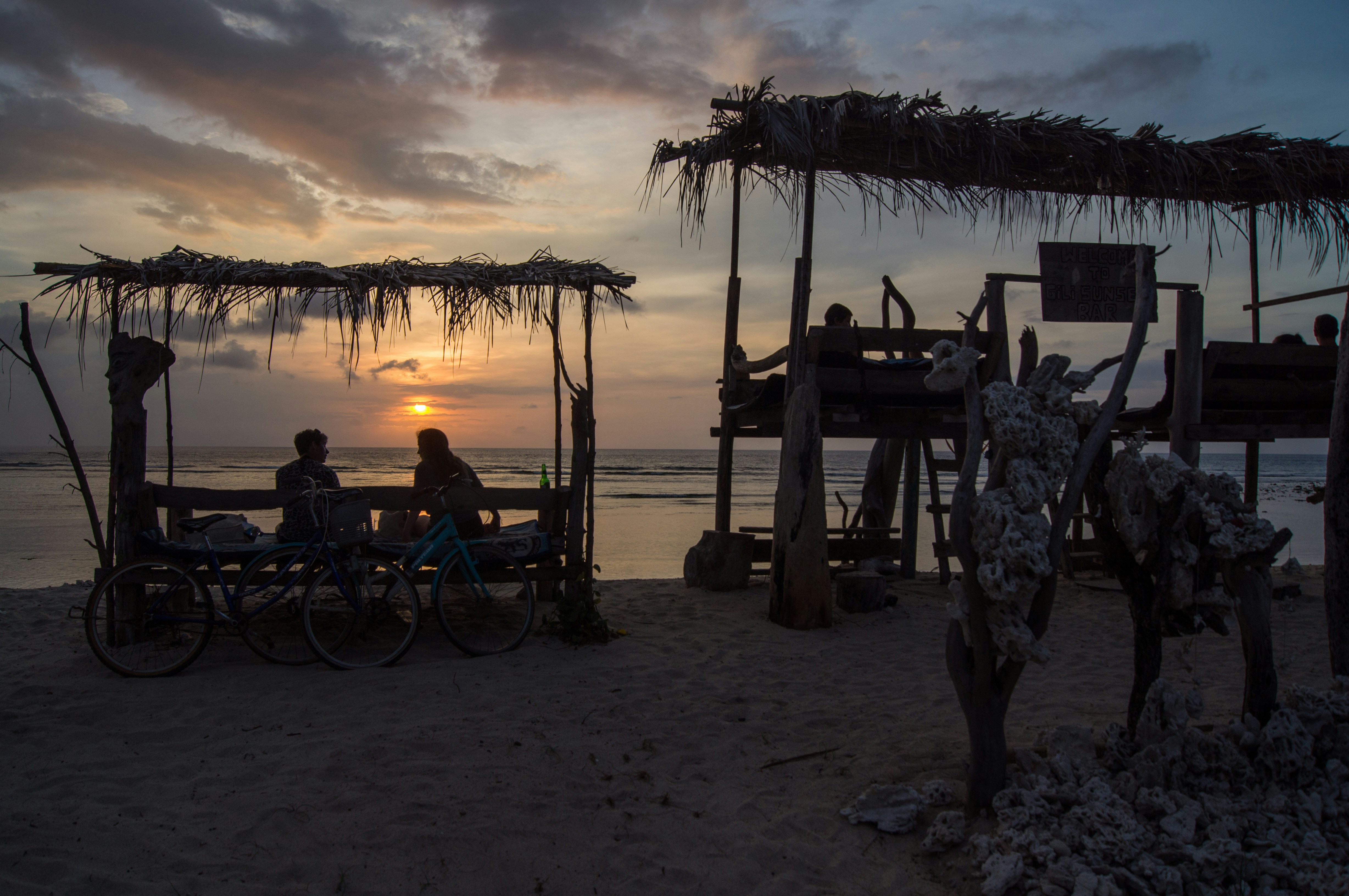a couple of people sitting on top of a beach
