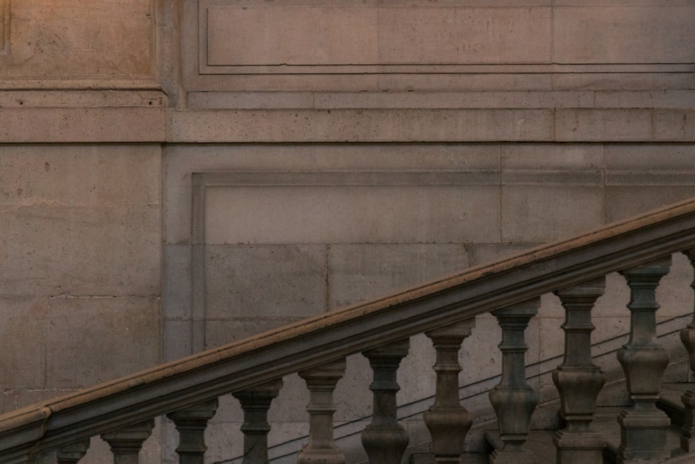 a clock on the side of a building next to a stair case