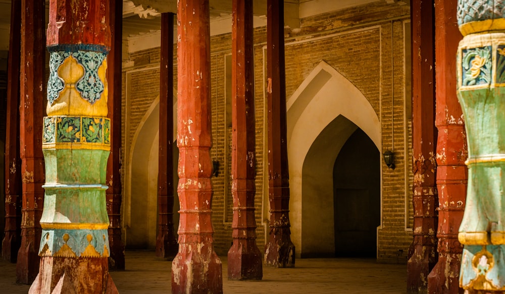 a building with pillars and arches painted with different colors