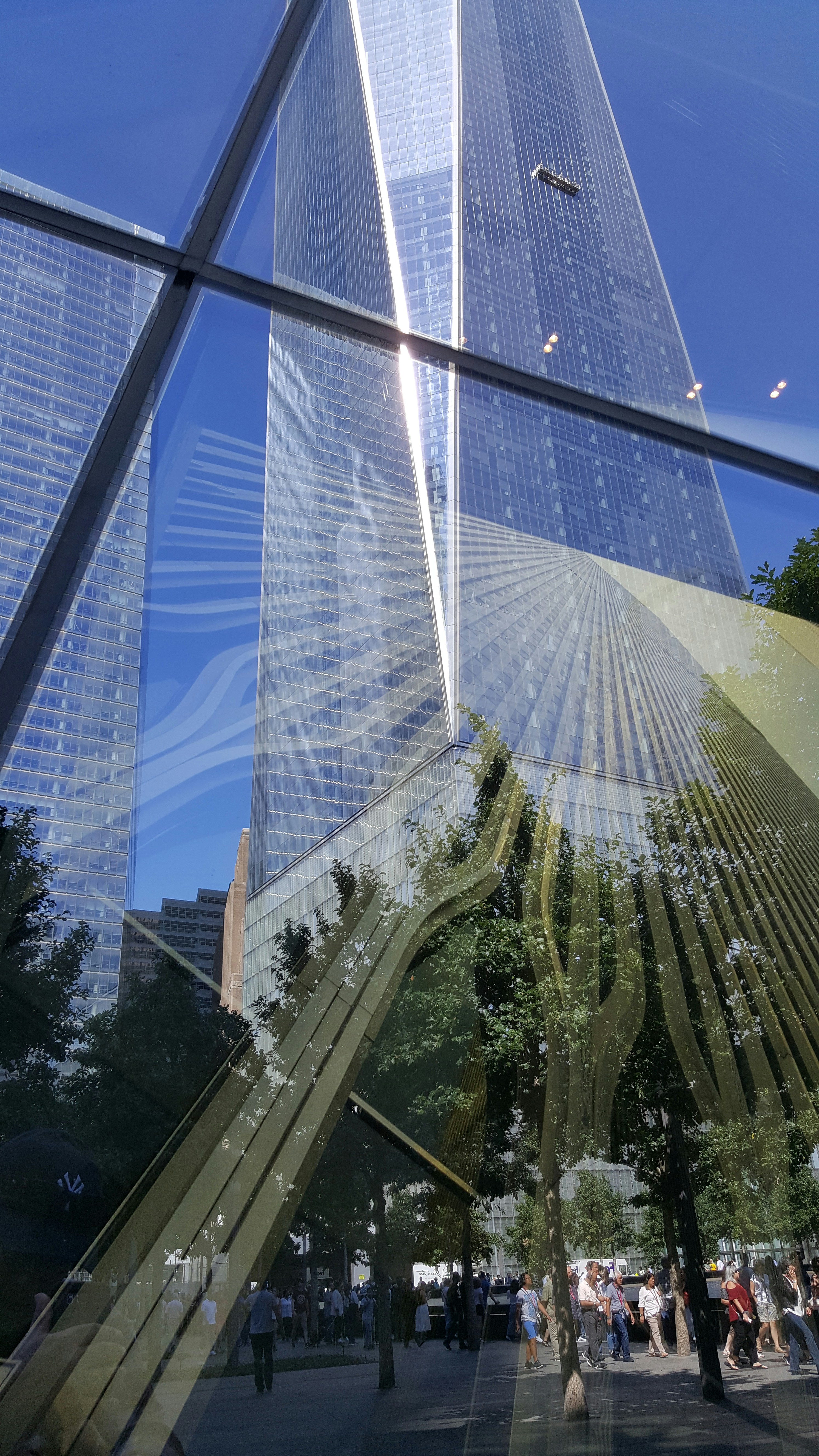 a reflection of a skyscraper in a glass window