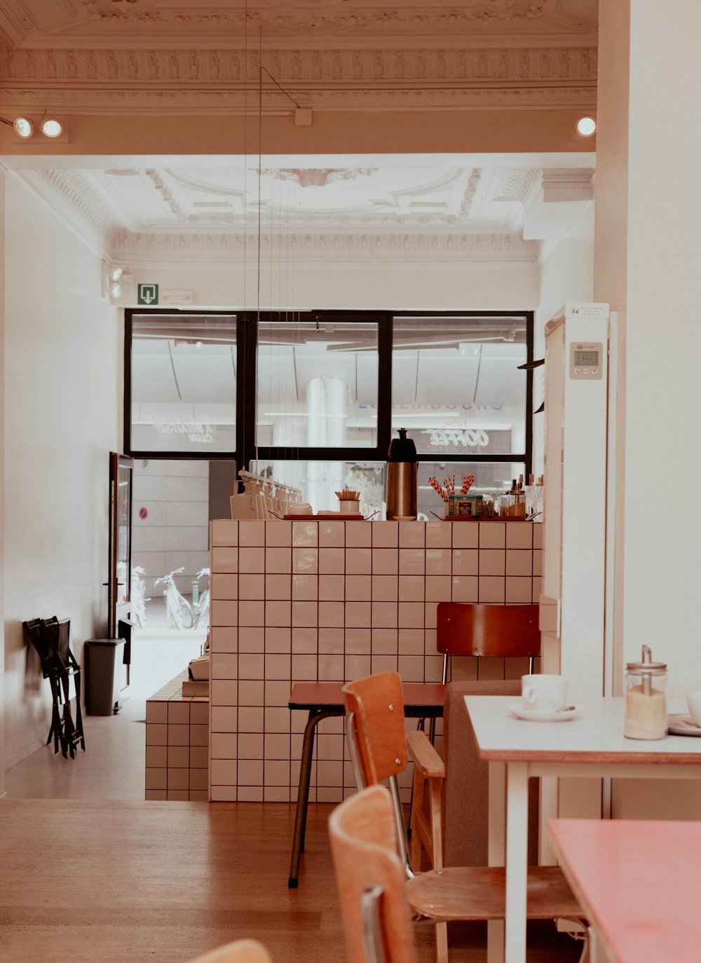 a room with a table, chairs, and a counter