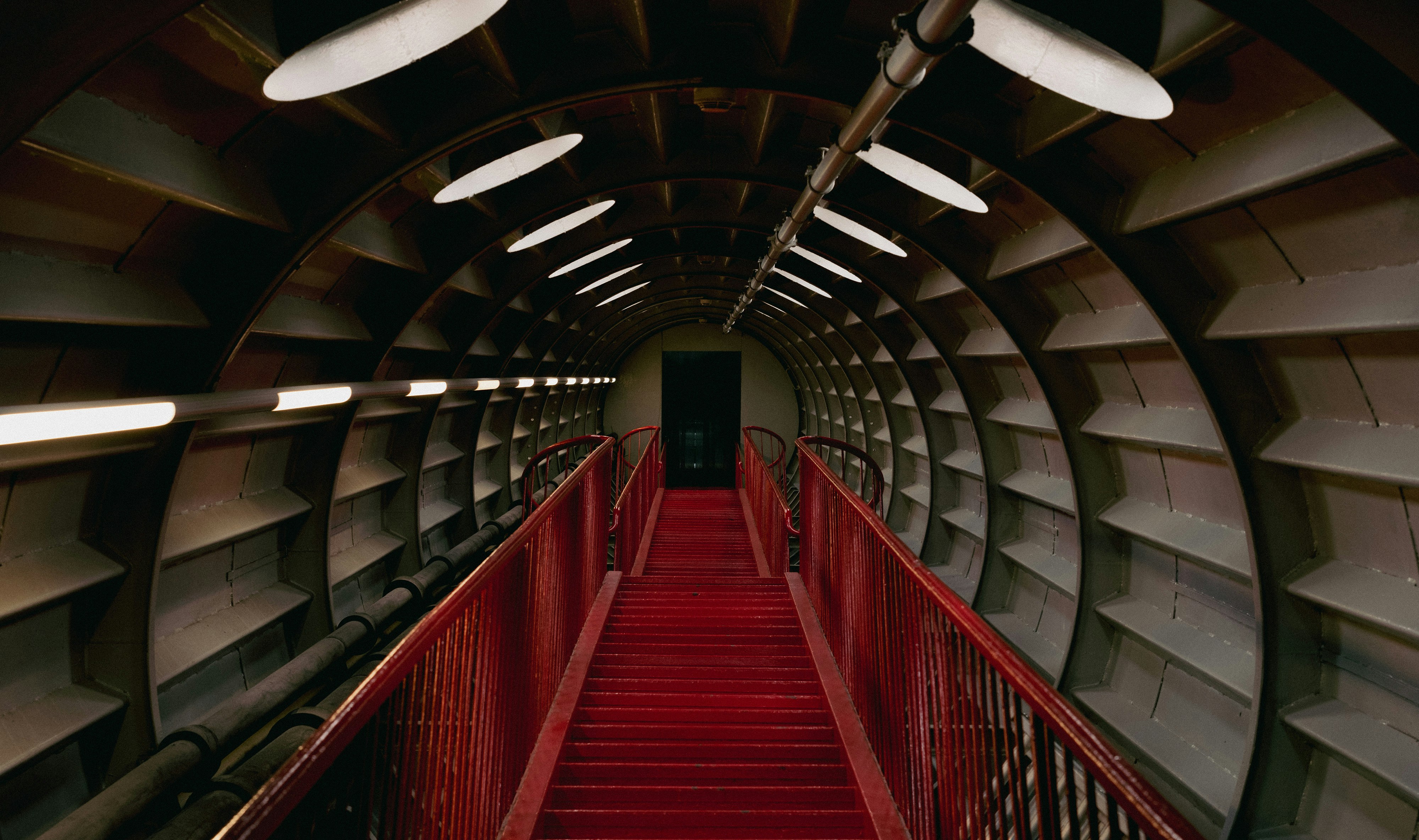 a red staircase leading to the top of a building