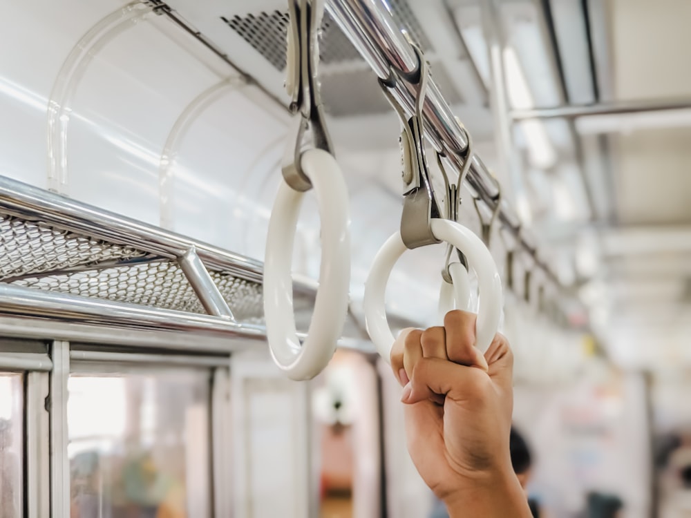 a hand holding a pair of scissors on a bus