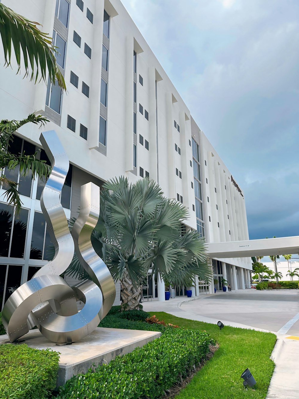 a large building with a sculpture in front of it