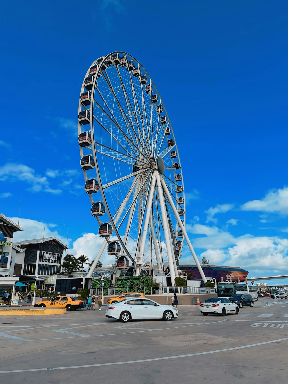 a large ferris wheel sitting next to a parking lot