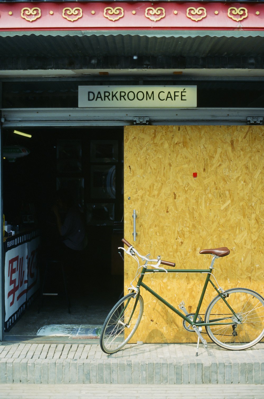 a bicycle parked in front of a wooden building