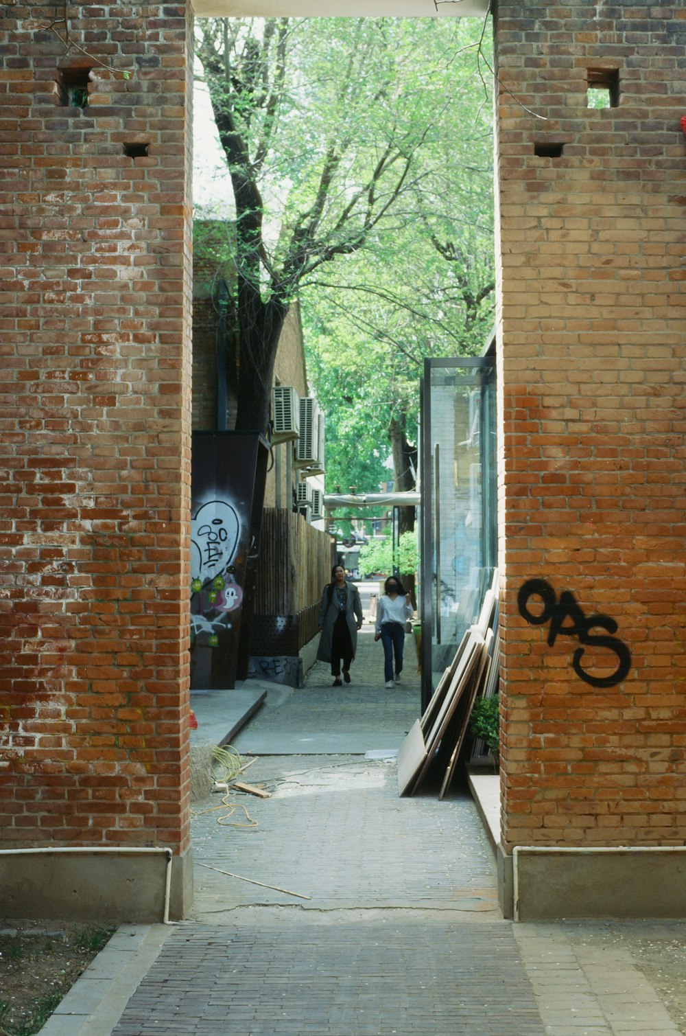 a brick building with graffiti on the side of it