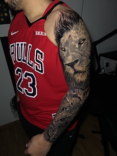 a man with a lion tattoo on his arm