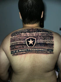 a man with a tattoo on his back