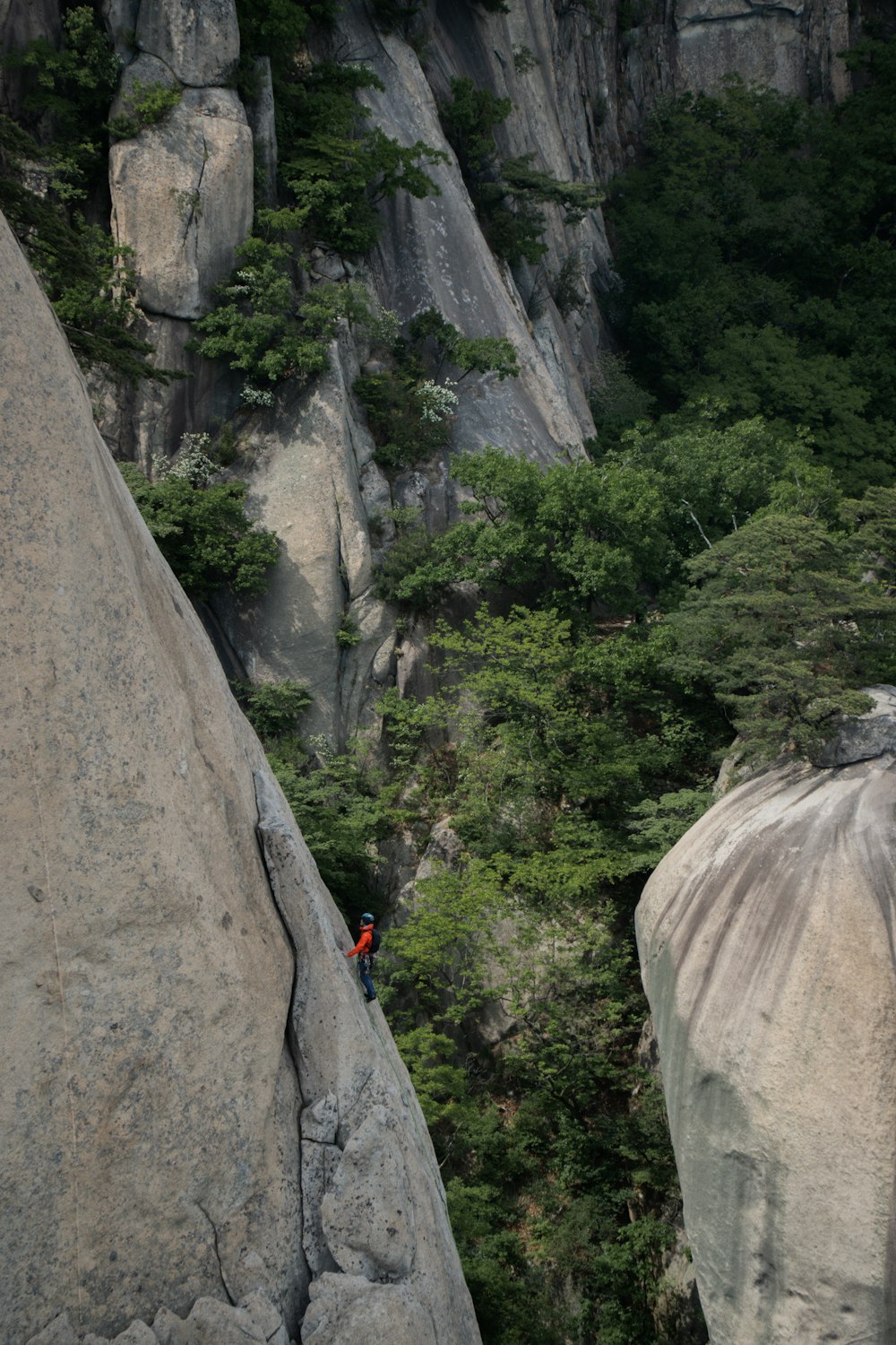 a man climbing up the side of a mountain