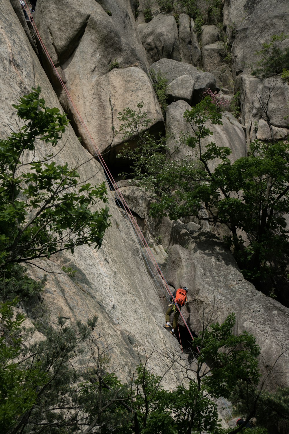 a man climbing up the side of a mountain