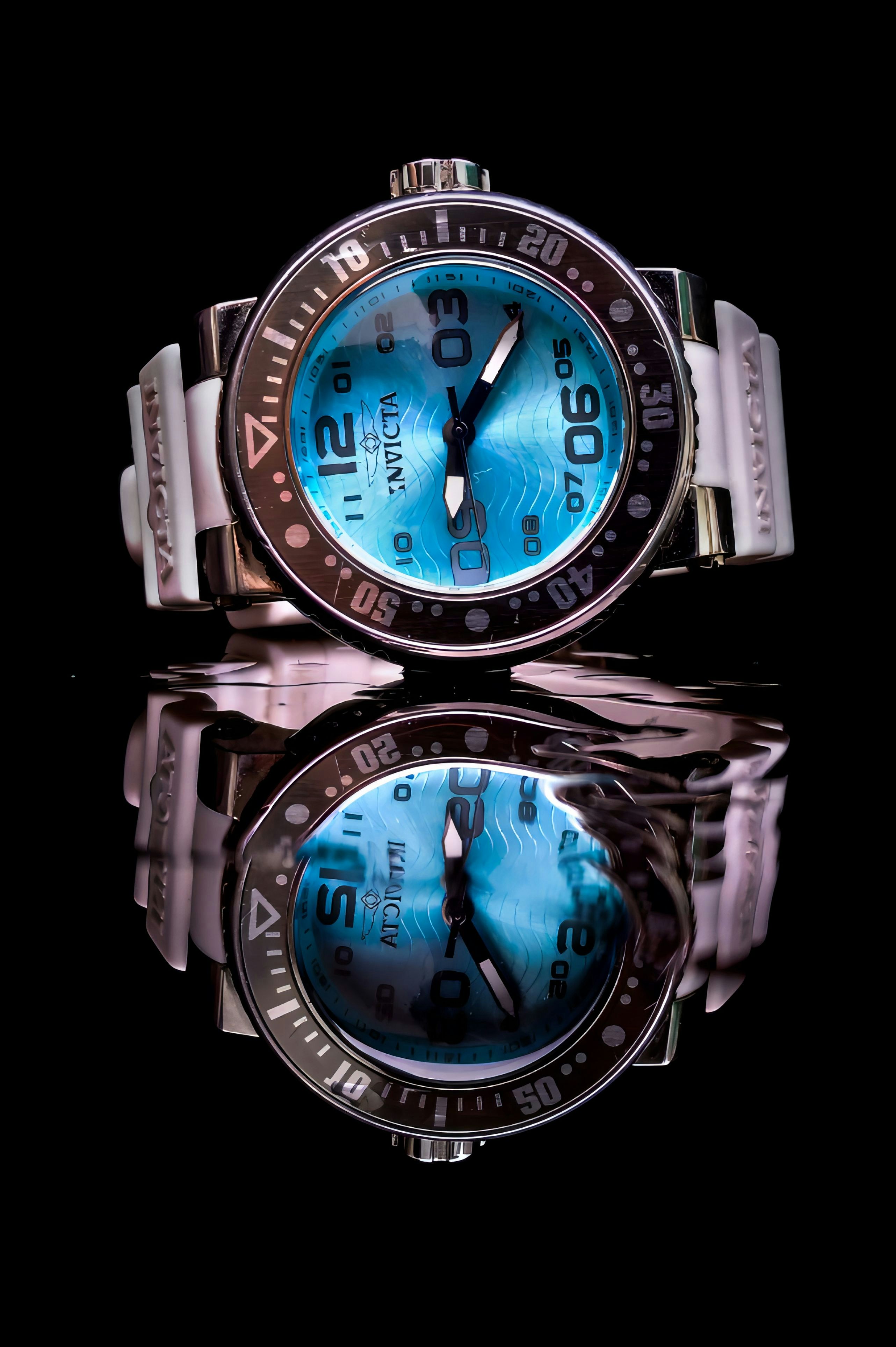 a close up of a watch on a black surface
