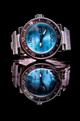 a close up of a watch on a black surface