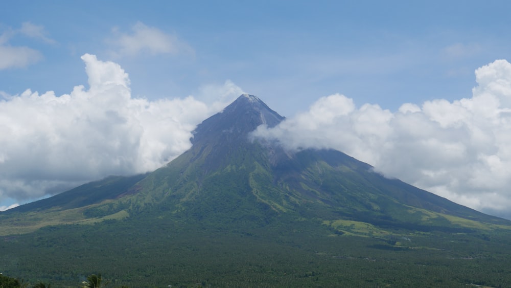 a very tall mountain with a cloud in the sky