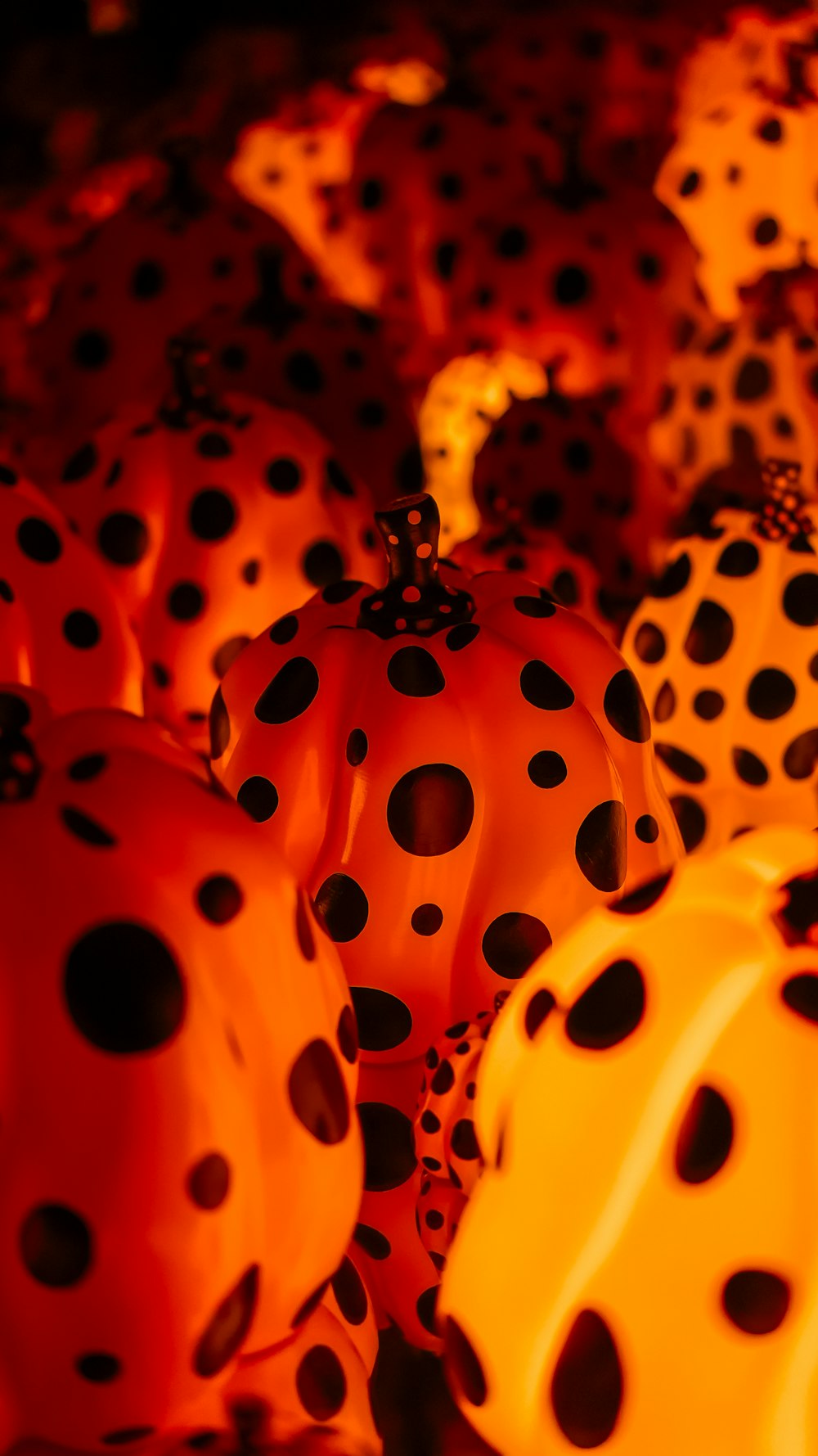 a group of polka dot pumpkins sitting on top of each other