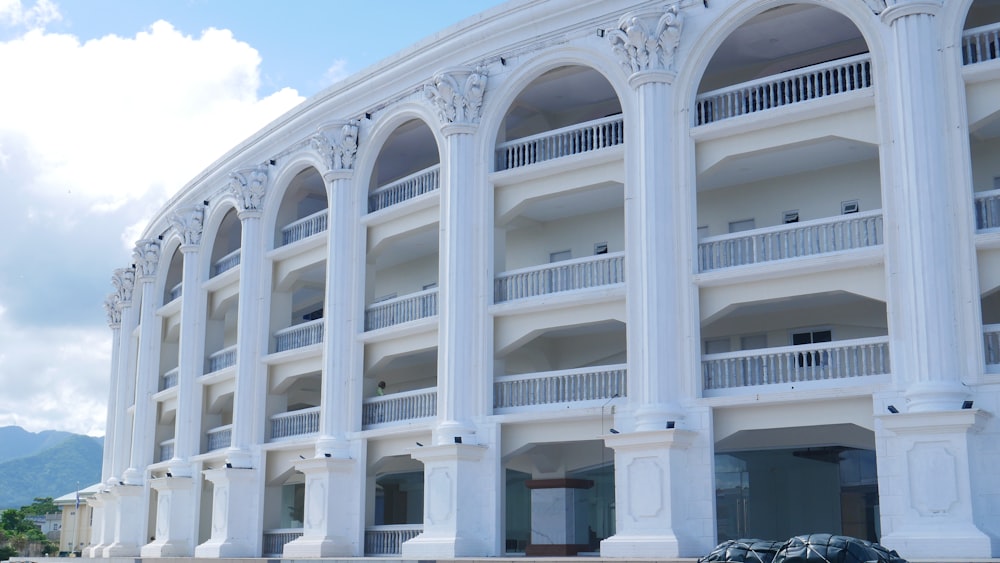 a large white building with arches and balconies