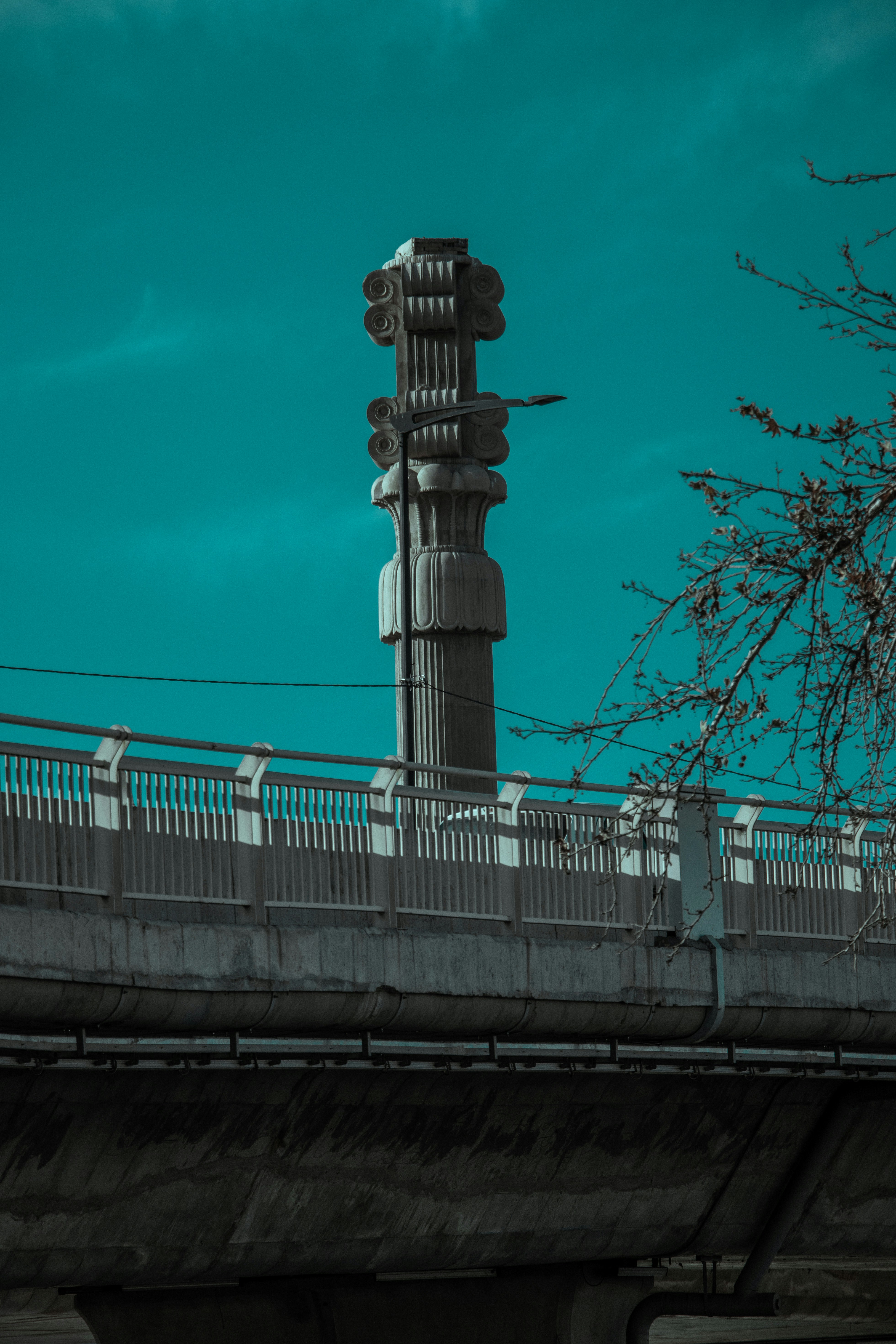 a clock tower on top of a bridge