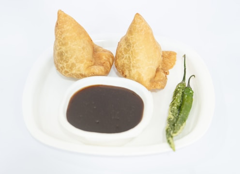 a white plate topped with two fried food items