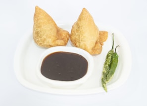 a white plate topped with two fried food items
