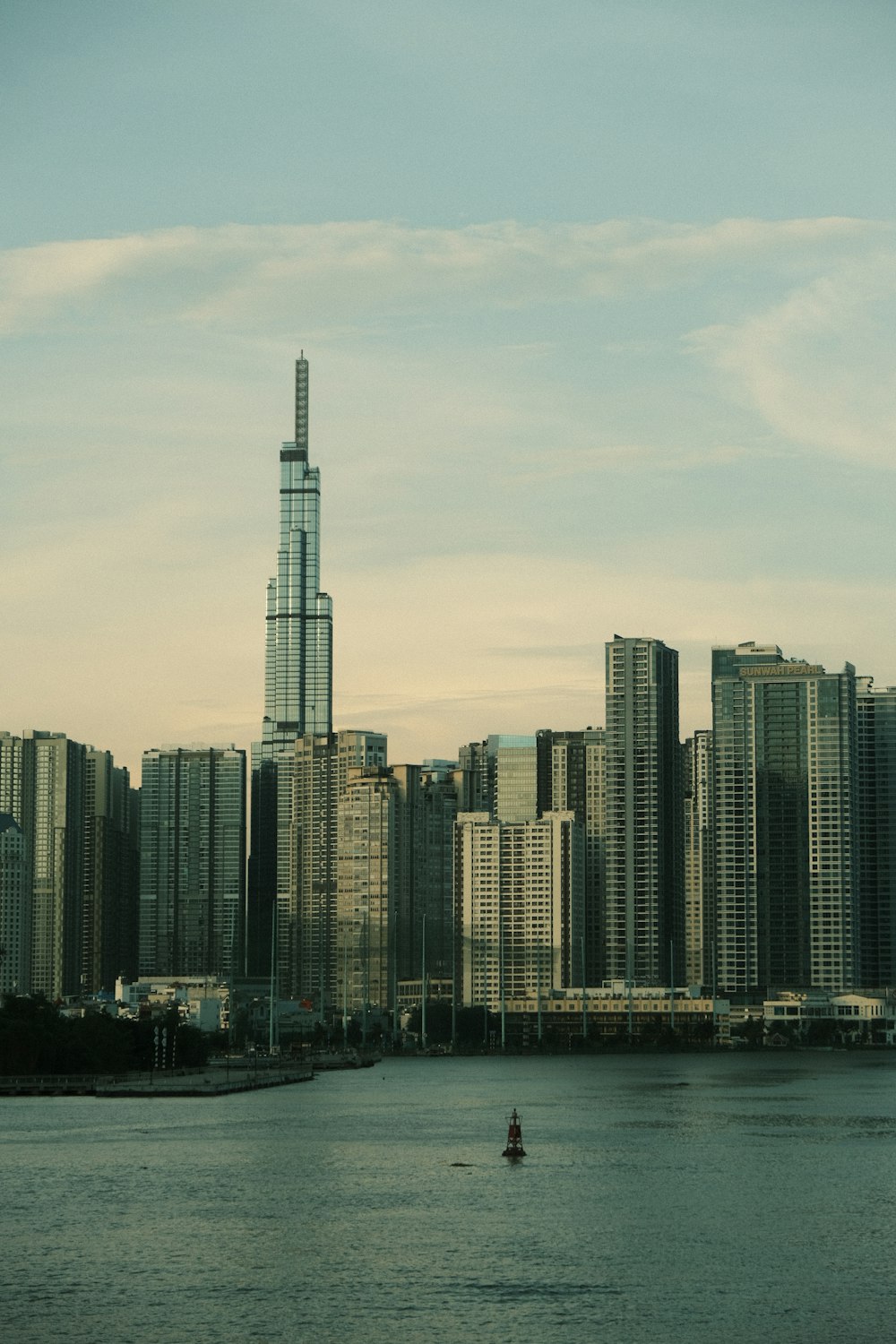 a large body of water with a city in the background