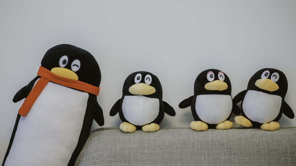 a group of stuffed penguins sitting next to each other
