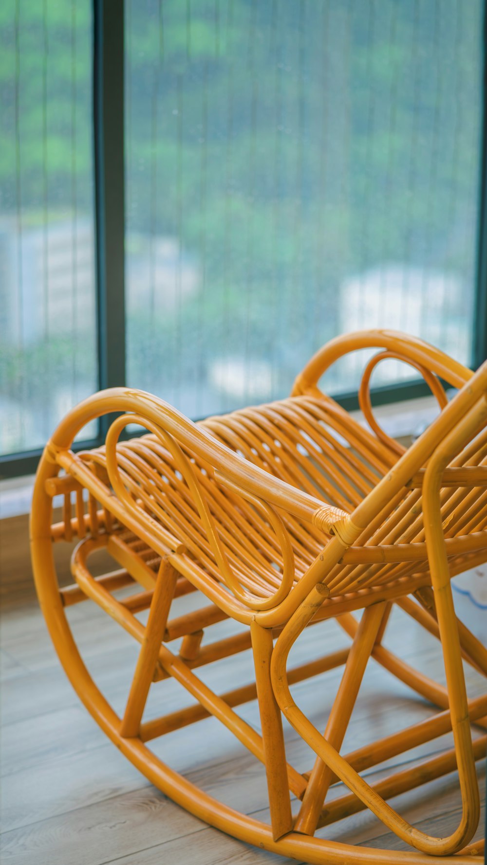 a yellow rocking chair sitting on top of a hard wood floor