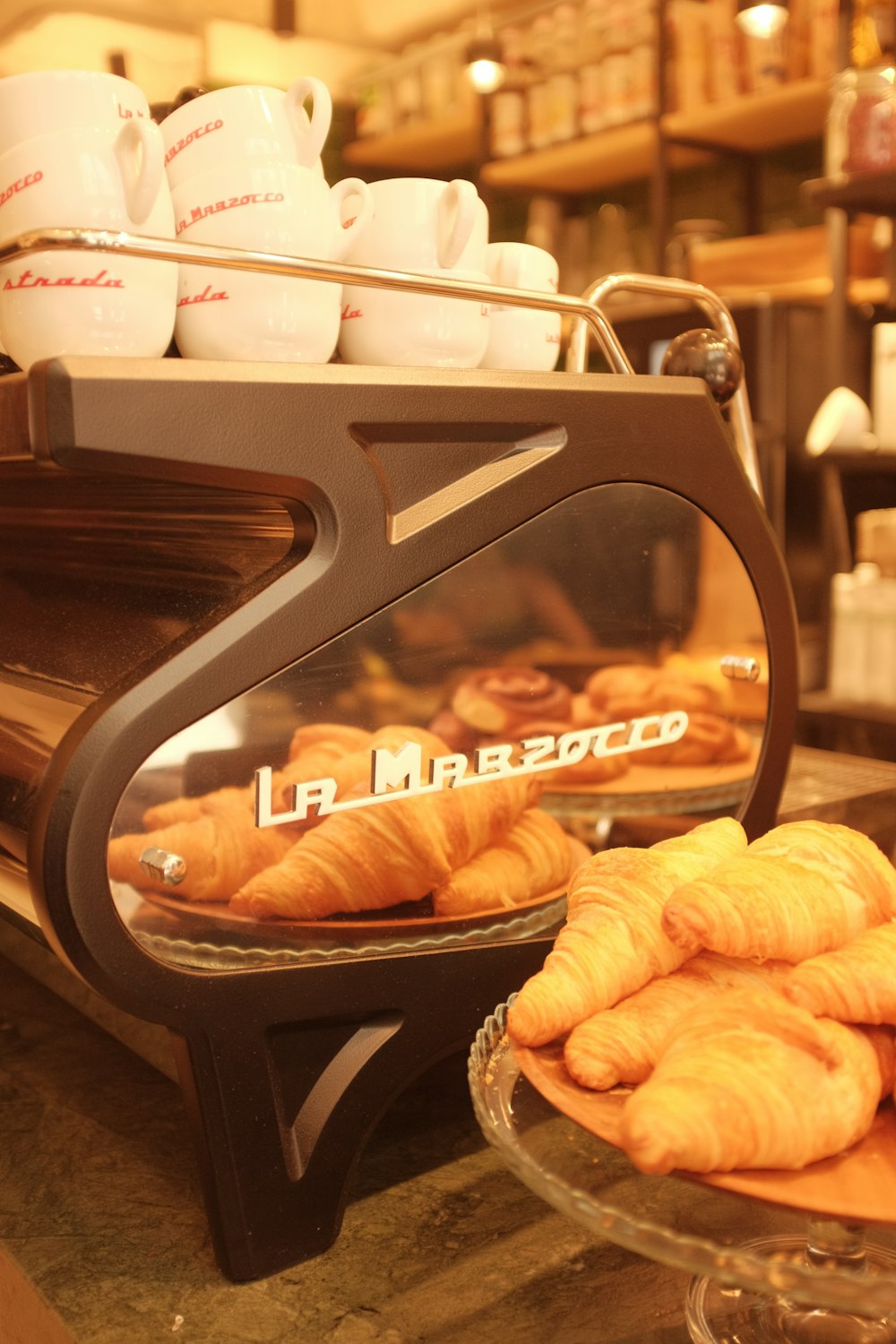 croissants and pastries on a counter in a bakery