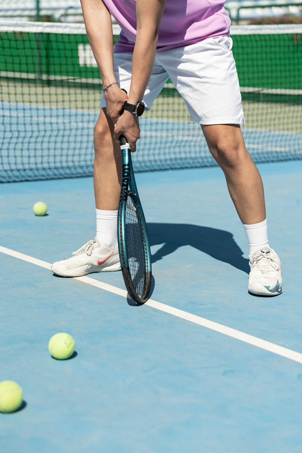 a man holding a tennis racquet on top of a tennis court