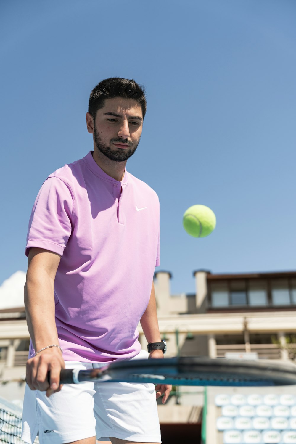 a man holding a tennis racquet on top of a tennis court