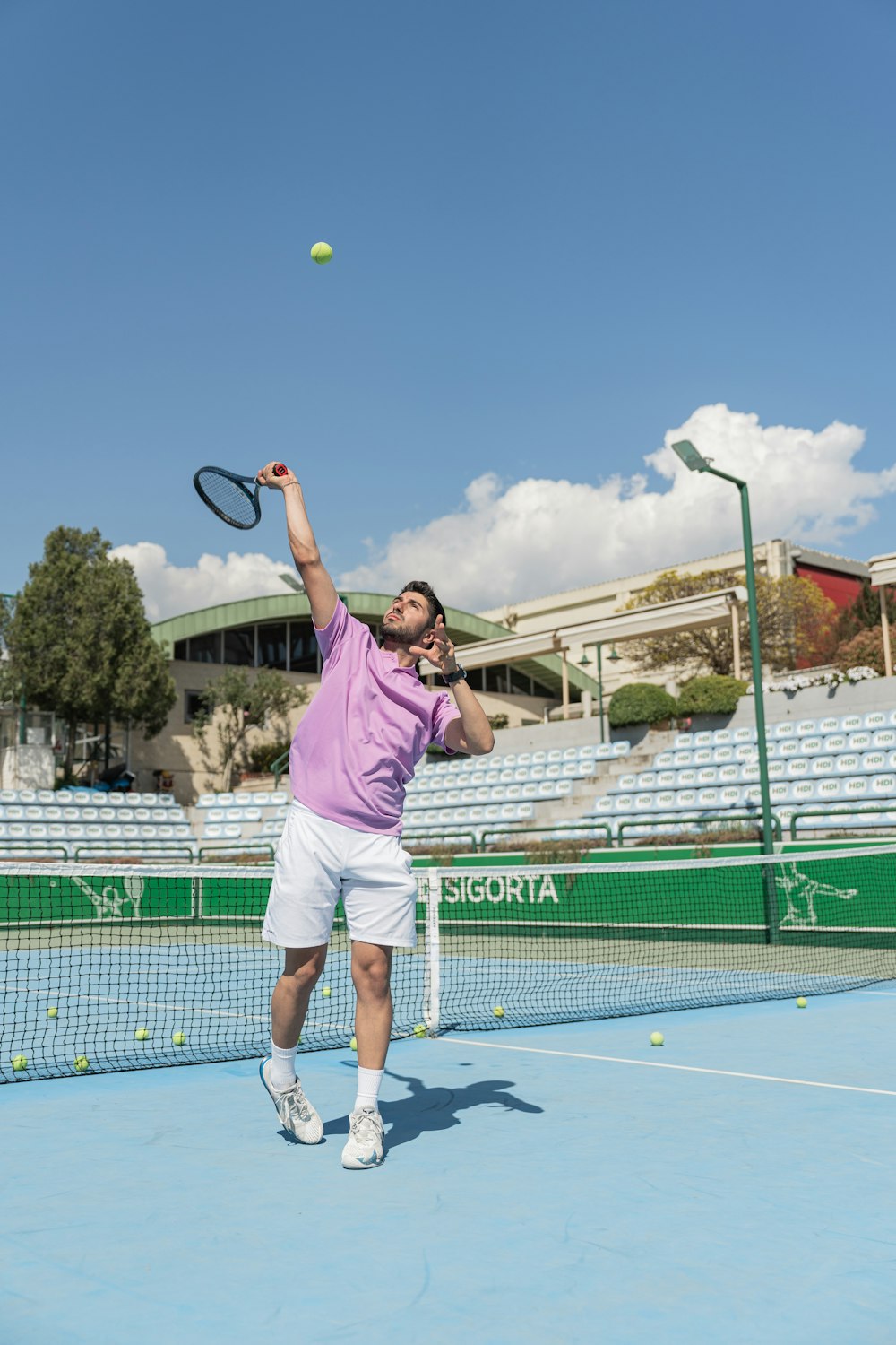 a man in a pink shirt is playing tennis
