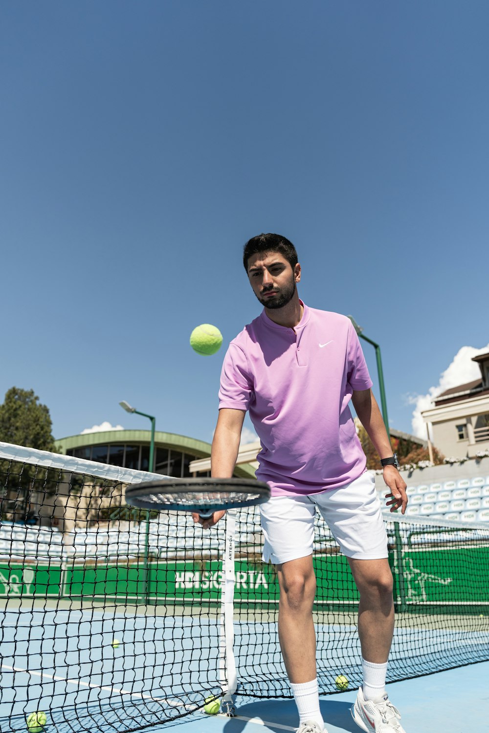 a man standing on a tennis court holding a racquet