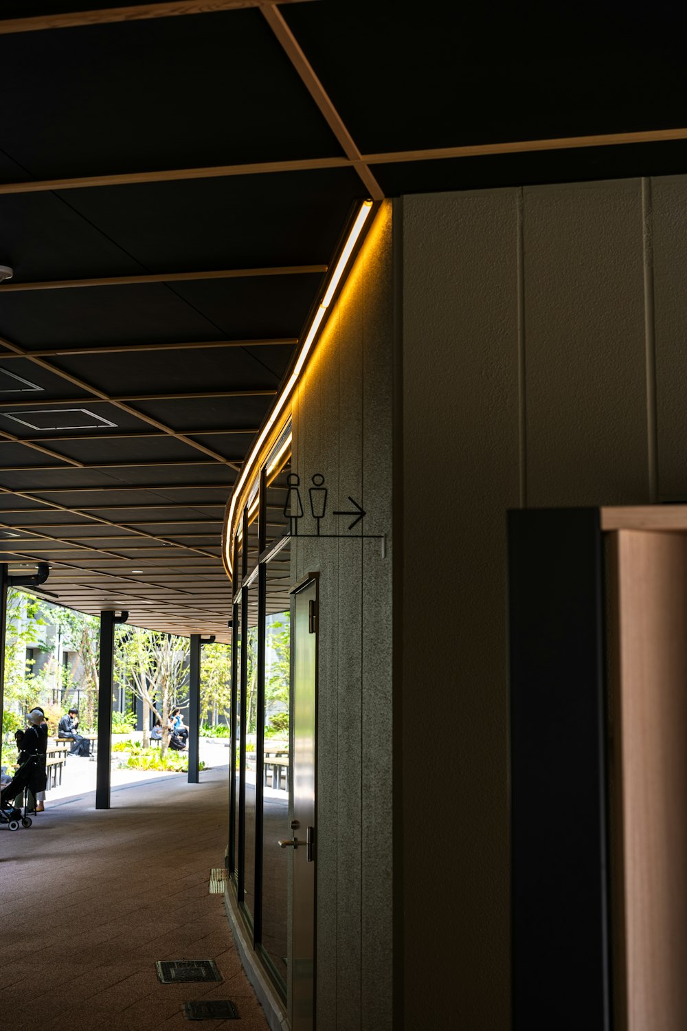 a long hallway with a light on the side of it