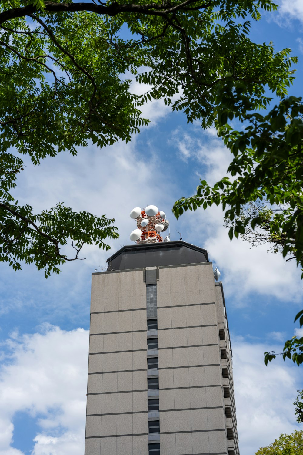 a tall building with a bunch of balloons on top of it