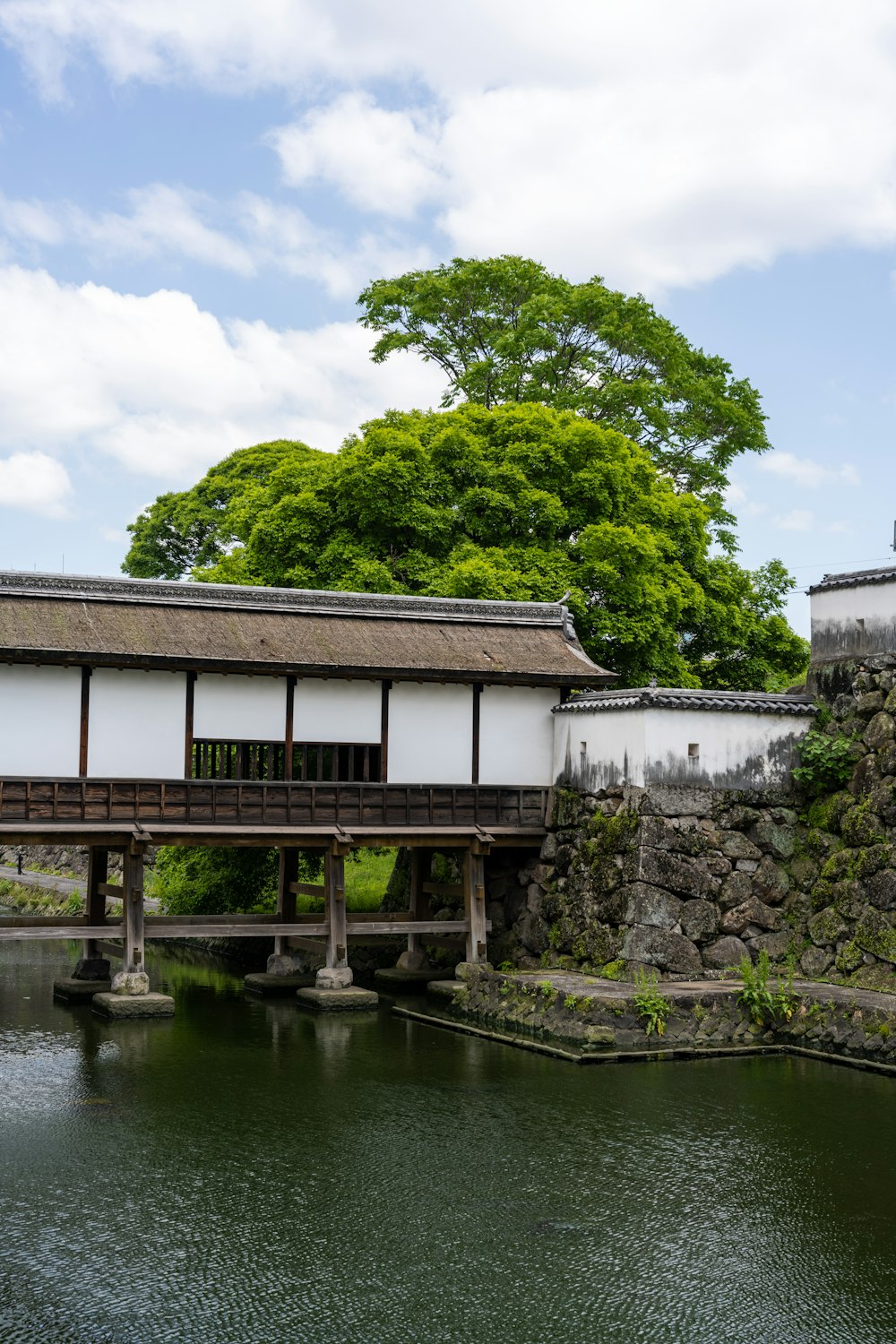 a bridge over a body of water next to a building