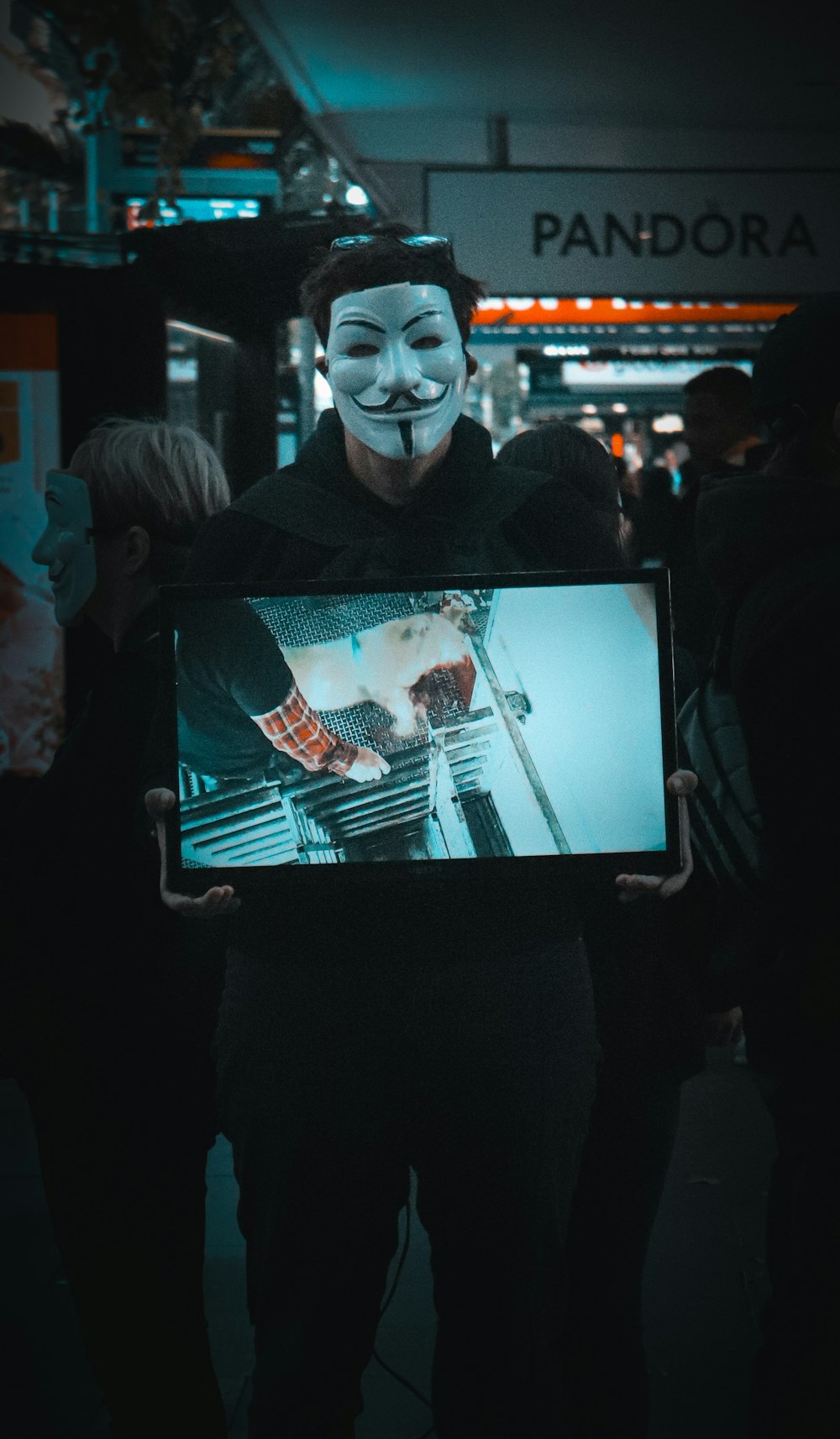 a man holding a picture of a guy in a mask