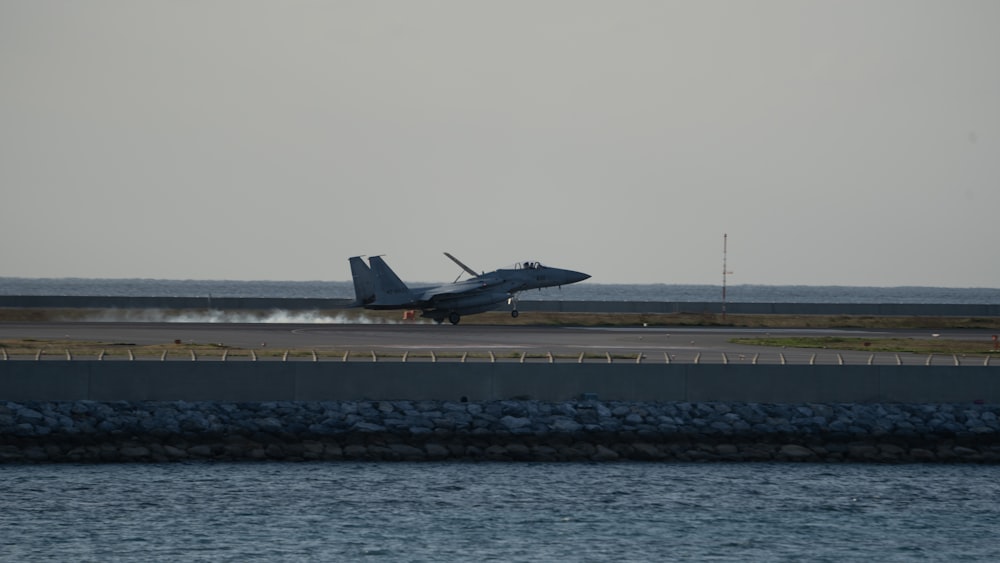 a fighter jet taking off from an airport runway