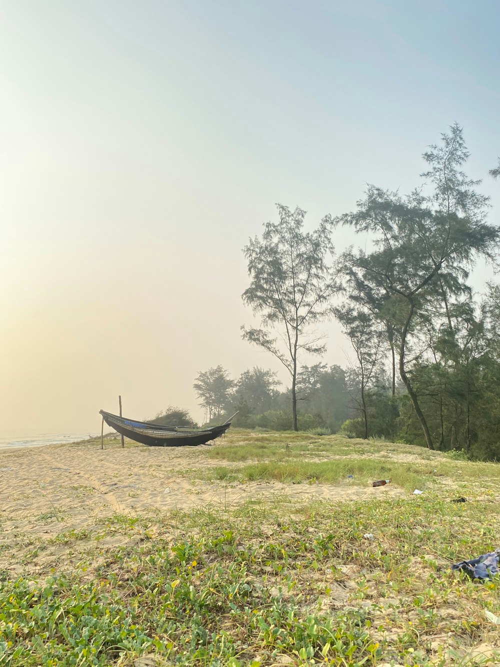 a hammock sitting on top of a grass covered field