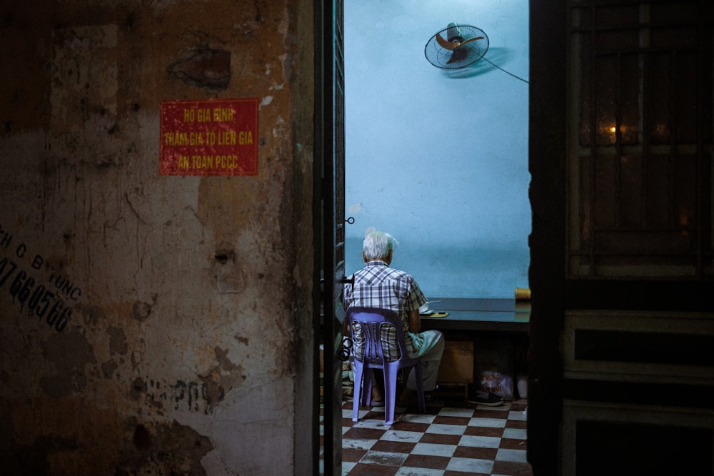 a man standing in a room with a checkered floor