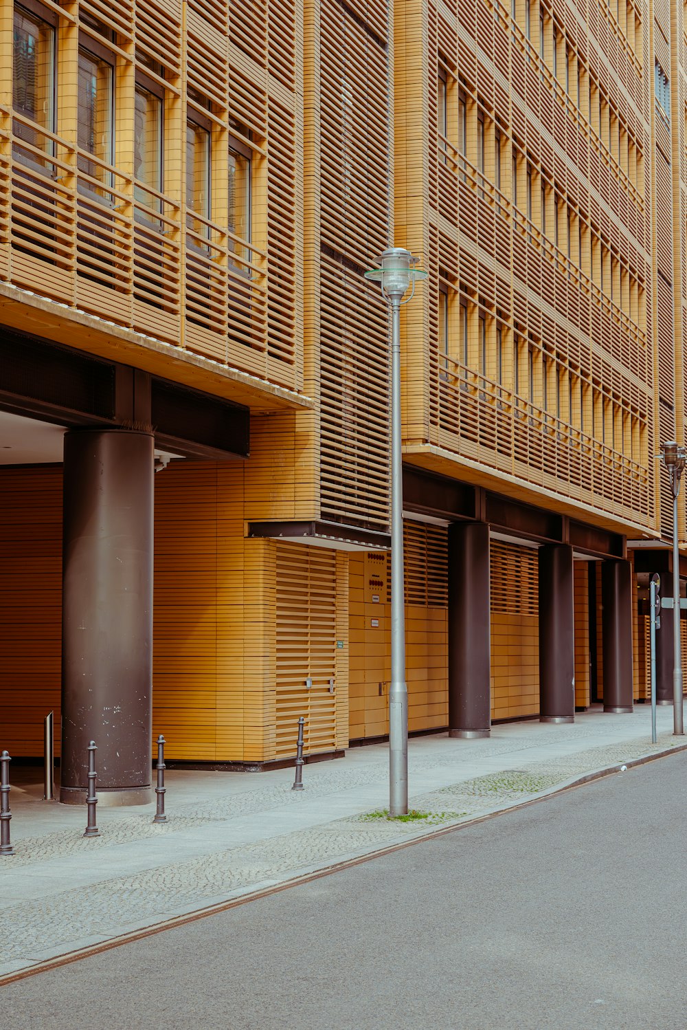 an empty street in front of a tall building