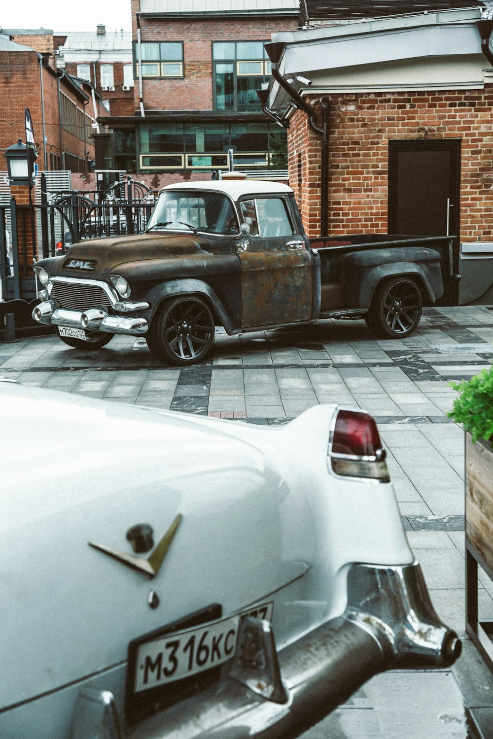 an old truck parked in front of a brick building