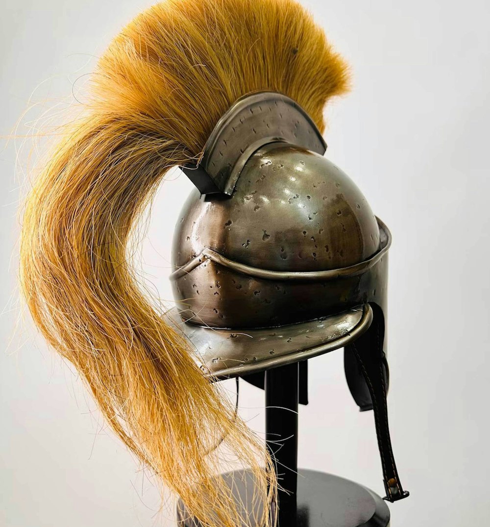 a helmet with a yellow tail on a stand
